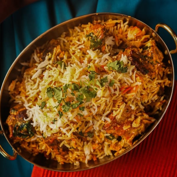 Chaska Indian Restaurant's biryani, a flavorful rice dish with meat and spices, garnished with fresh cilantro.
